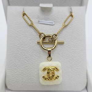 Authentic CHANEL Gold and Cream Logo Necklace. On Atolea Waterproof Chain